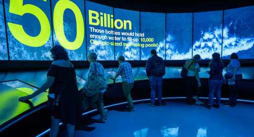 Guests and large curved video wall showing "50 billion" statistic