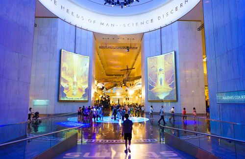 Person in silhouette walking toward Museum Rotunda space