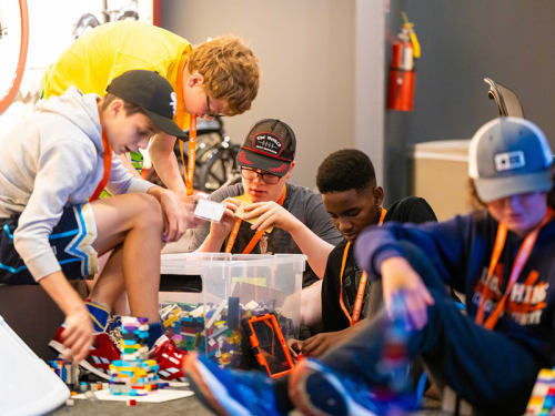 Campers sorting and building with LEGO® bricks