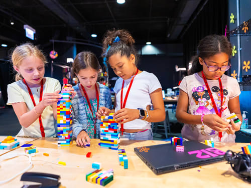 Four campers collaborate on building with LEGO® bricks