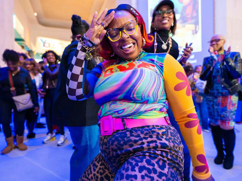 Smiling woman poses while dancing in a crowd