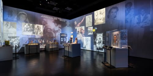 A gallery shot of "Crafting Character: The Costumes of Paul Tazewell" displaying artifacts from Tazewell's beginnings and inspirations..