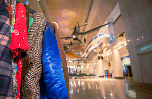Closeup of hanging vintage clothes with Transportation Gallery in background