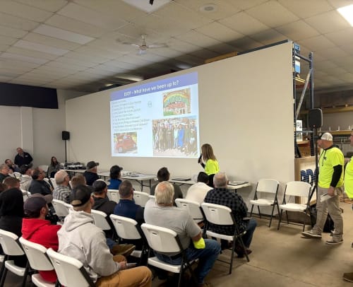 PDC presenting safety standards to new hires on a projector