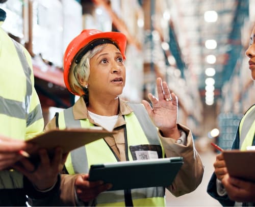 Engineer in PDC hard hat conducting an electrical construction evaluation