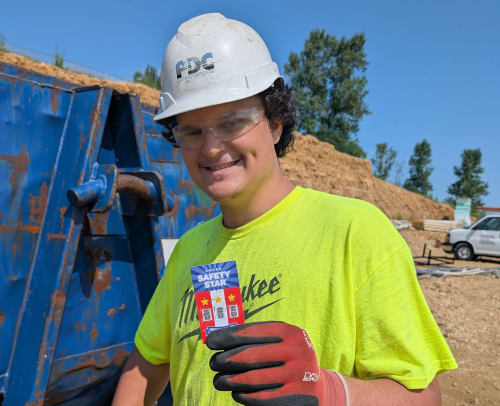 Electrical contractor holding a safety checklist on a job site