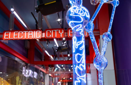 Electric City sign above with tall glowing posts in foreground