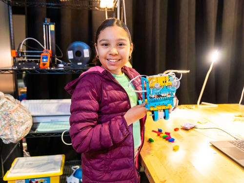A young camper proudly shows off a robot made during a Griffin MSI camp. 