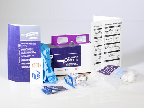 The contents of the "Purple" Science Curiosity Kit featuring activities Garden in a Pouch, Can You See Your Lights?, Balloon Buzz, and Who Did You Eat?