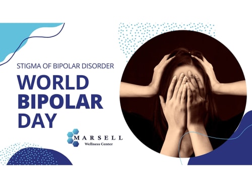 A woman is covering her face with her hands, while someone else has their hands on her head as well, conveying feelings of desperation and struggle.