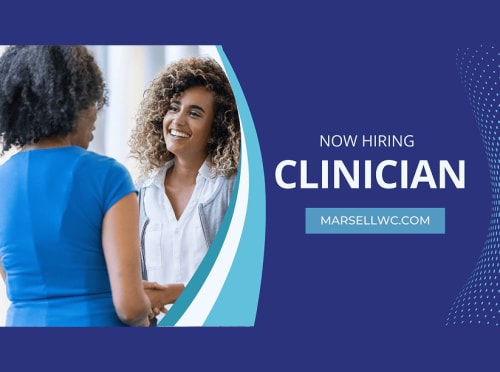 Woman smiling and greeting another woman in the work place.