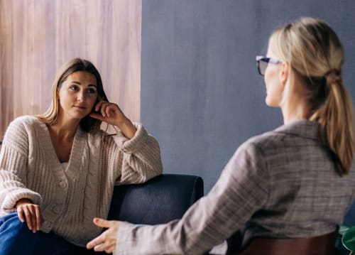 woman listening to counselor in individual therapy session