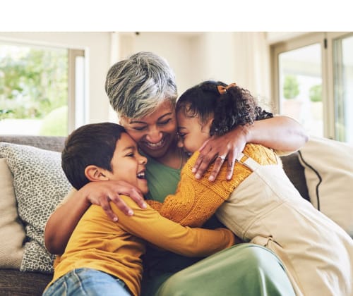 grandmother hugs her granddaughter and grandson