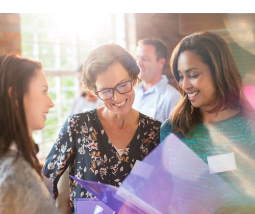 community partners looking through notes at an event