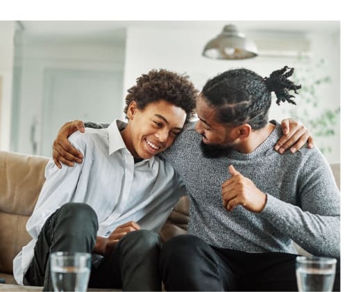 dad hugging his son in their living room