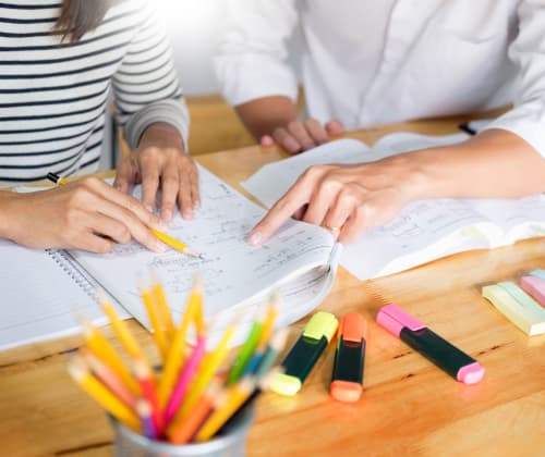 two teachers going through a lesson plan together