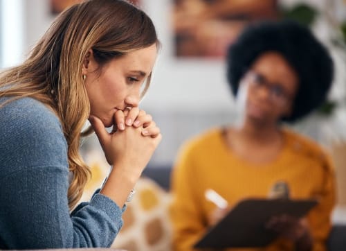 woman in an individual therapy session thinking