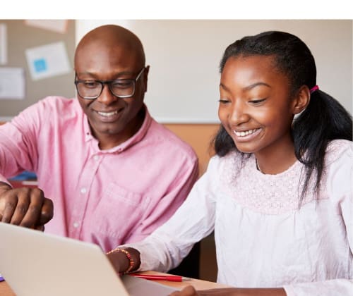 dad helping his daughter with her homework on a laptop