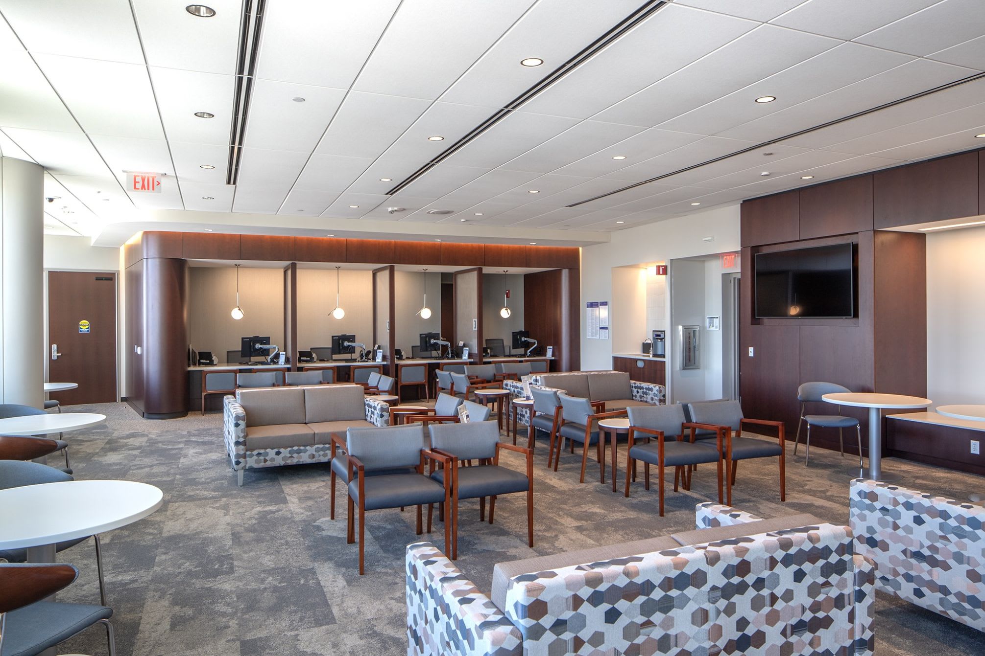 Large waiting room of a medical building with chairs and couches.