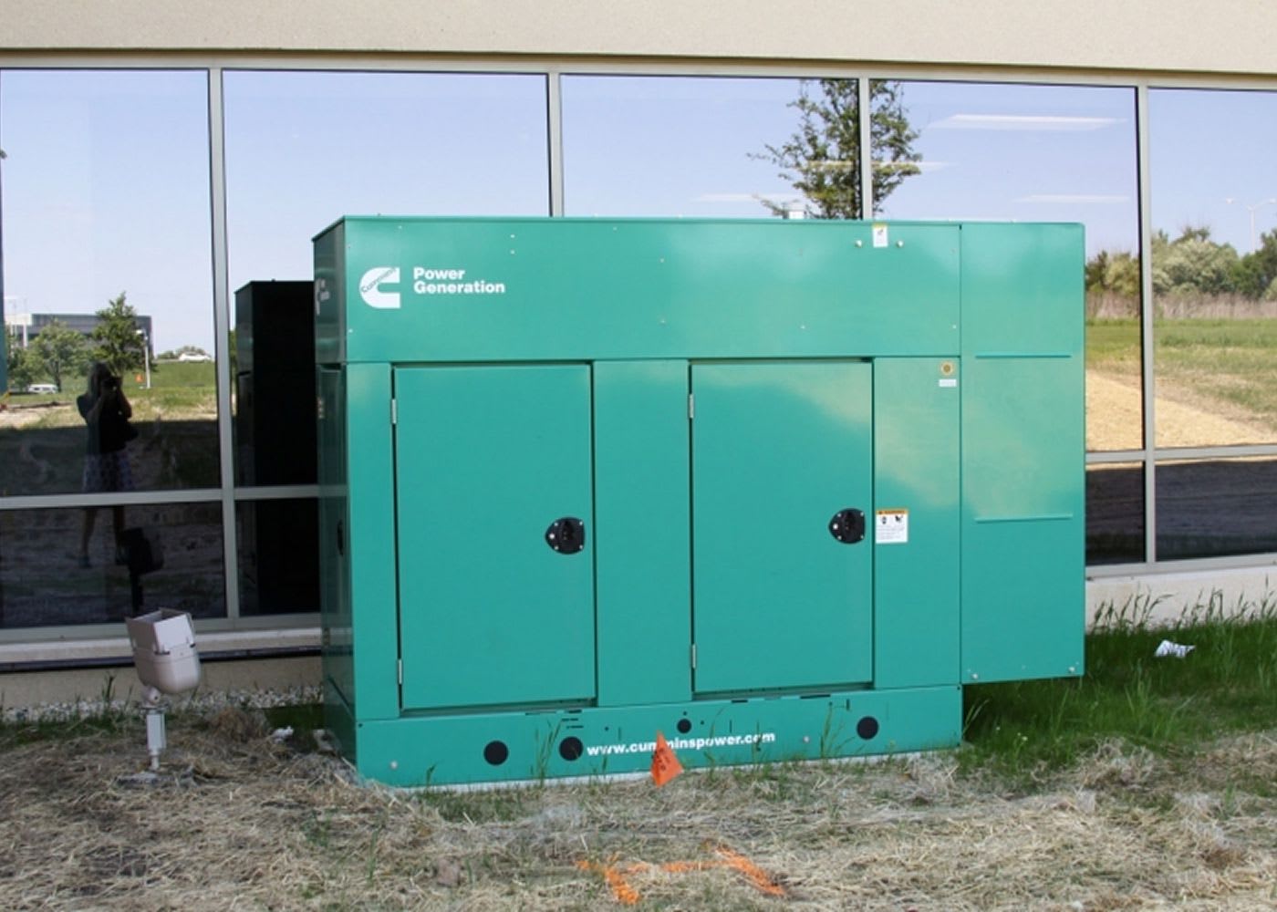 Blue power generator installed by Connelly Electric outside the building.
