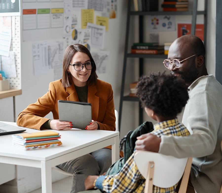 dad sitting with his son while getting the results of an educational assessment