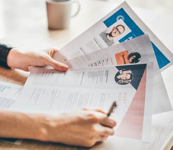 hiring manager fanning through resumes