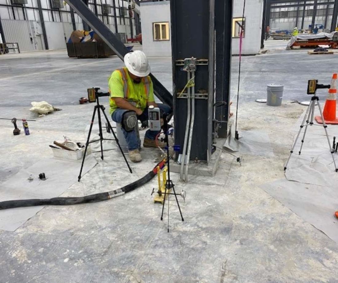 image of Superior Grouting employee performing polyurethane injection for crane stabilization project