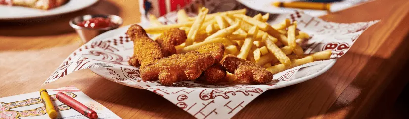 A plate of dino nuggets and fries from Beggars Pizza