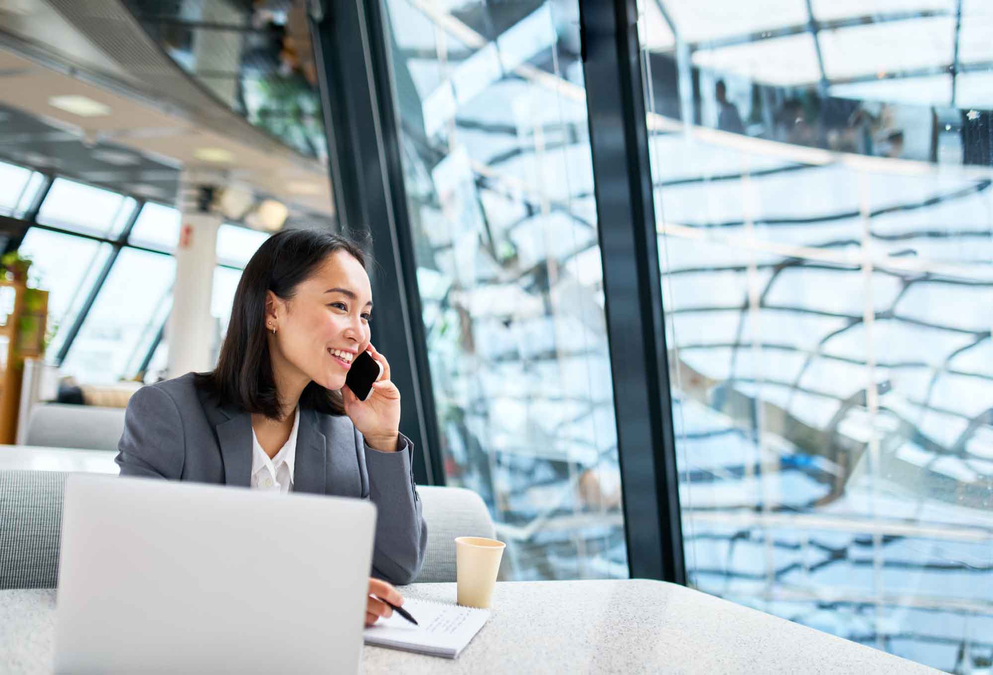 woman talking on phone on computer to c-suite level sales