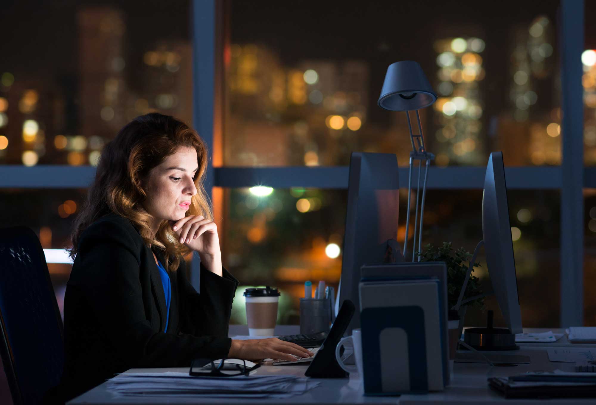 An office employee uses her computer | 5 Risky Employee Cyber security Issues in the Workplace | Impact