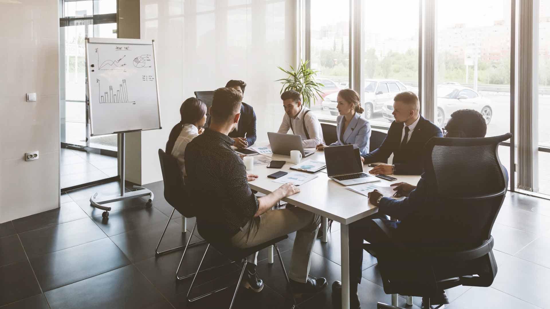 A group of marketers sitting around a conference table in an office