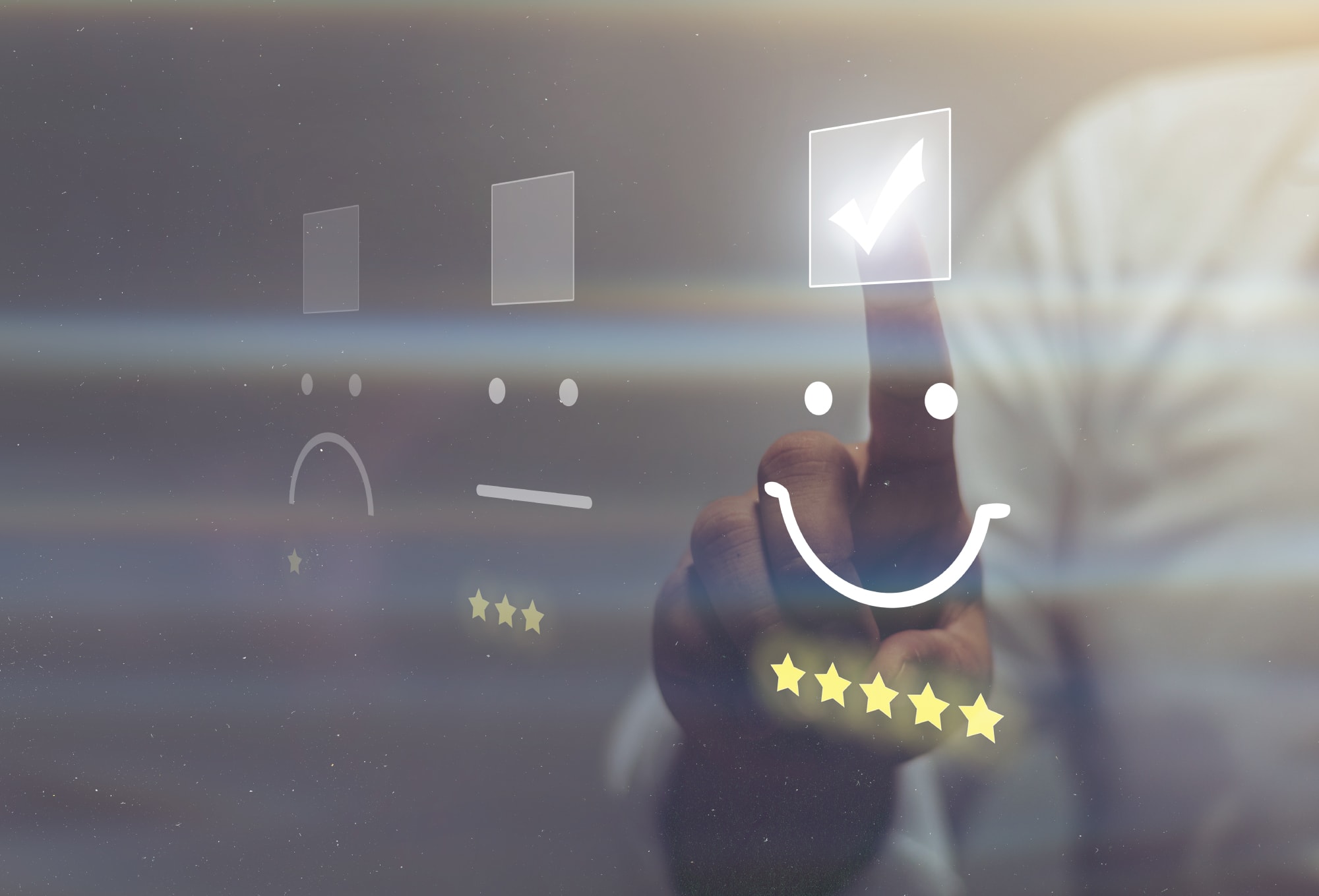 a sad face next to an uncertain face and a smiley face with the smiley face being selected by a human hand