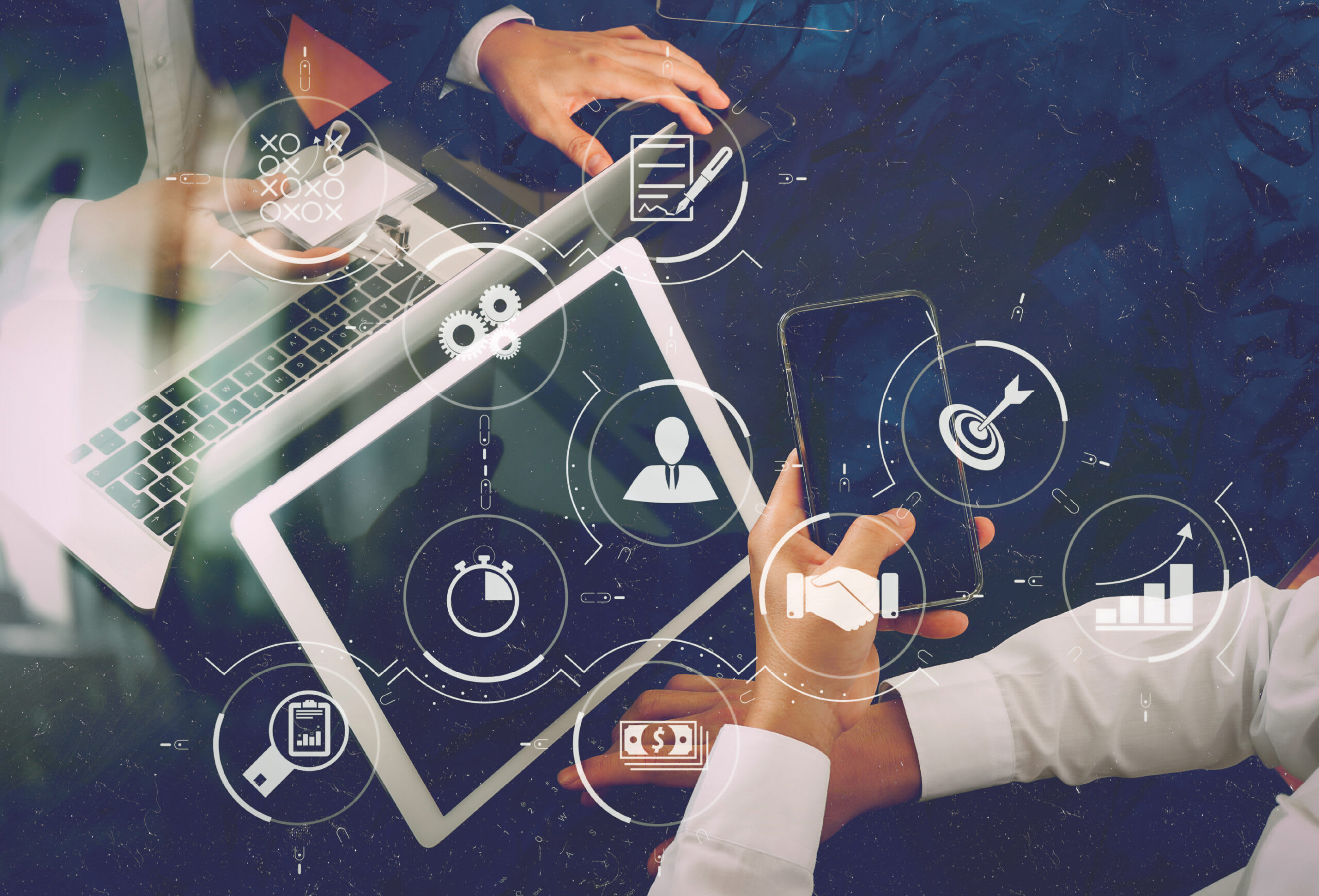 hand on ipad and phone with icons around