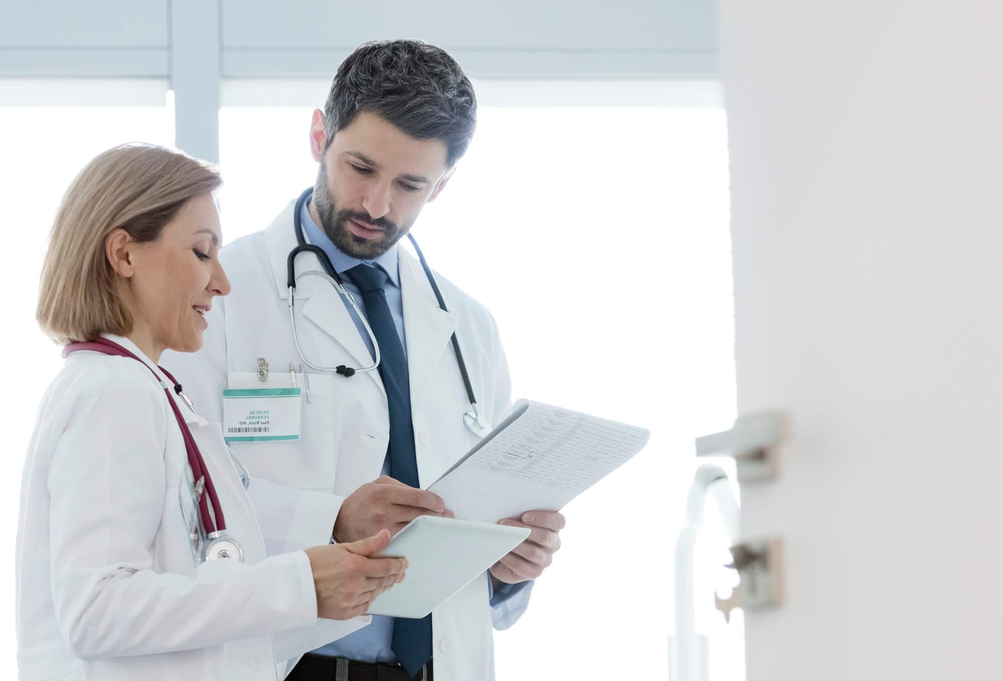 two doctors looking at a clipboard