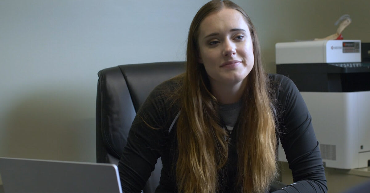director on lap top in a meeting