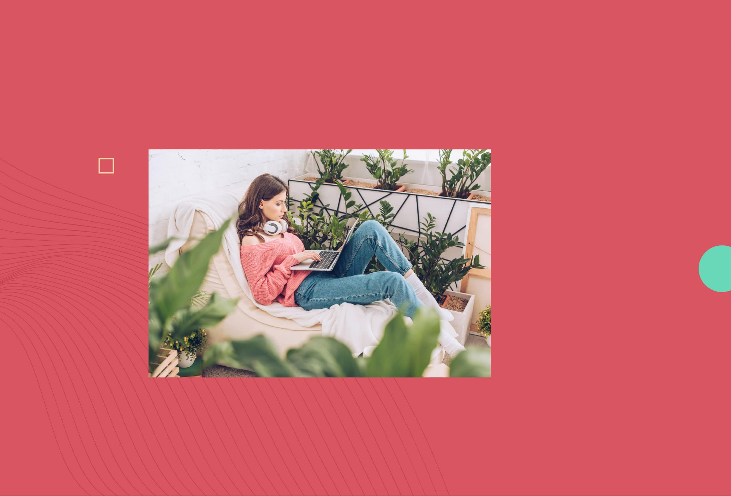 woman sitting with a laptop in her lap and headphones around her neck