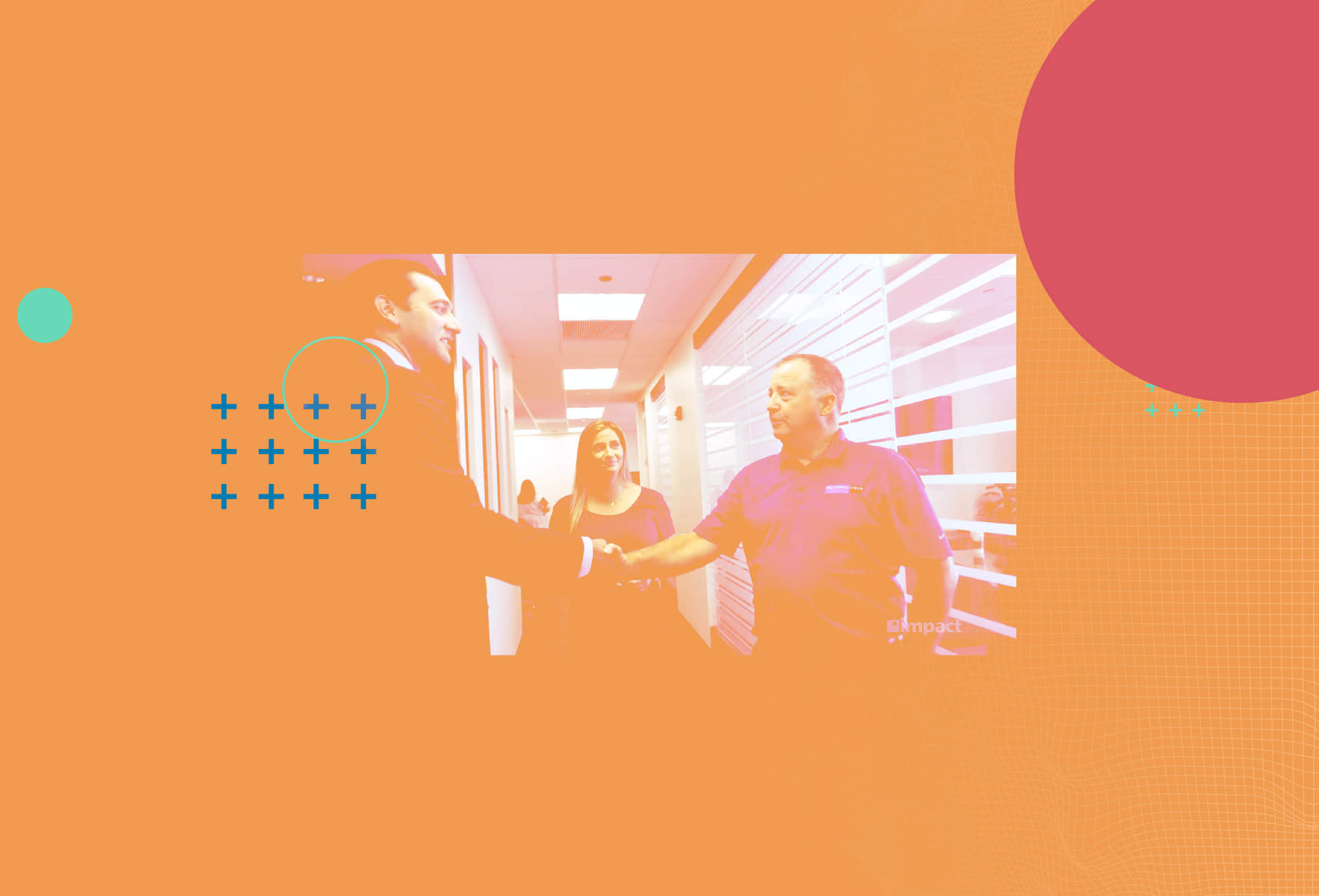 man in suit shaking hands with man in polo and female looking