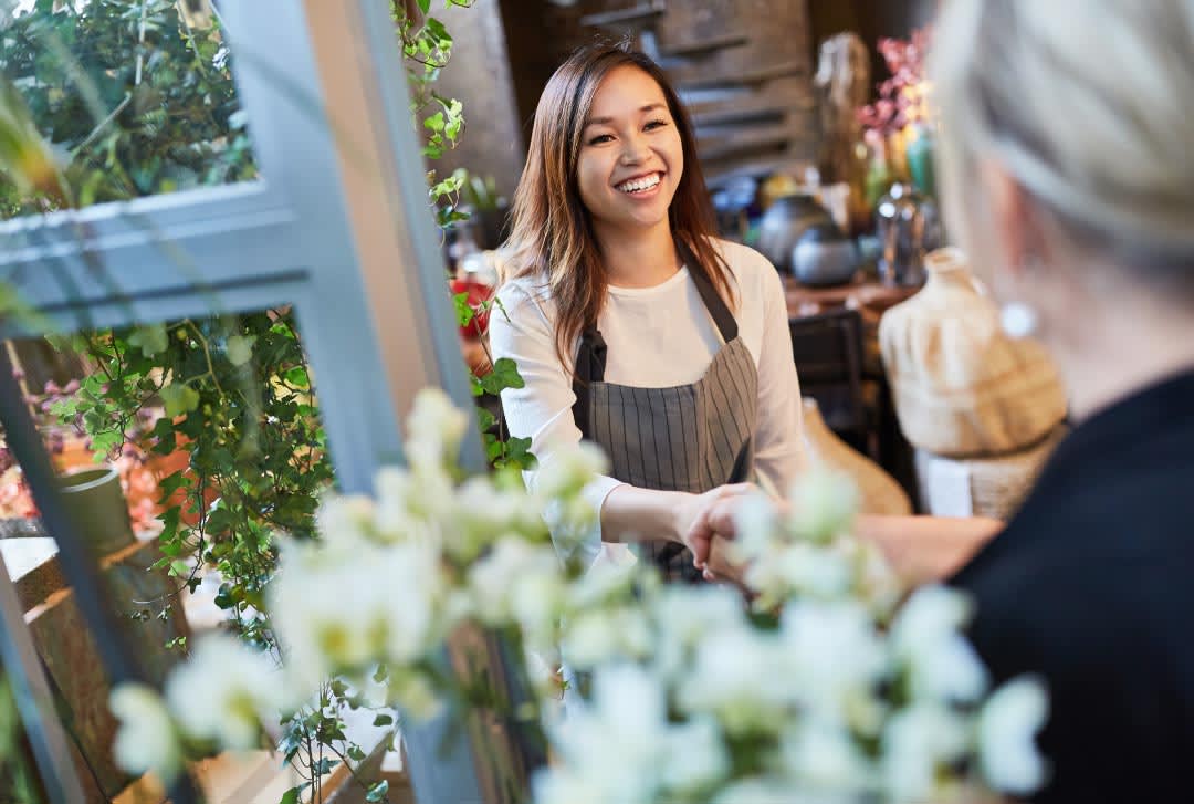 A happy customer at a floral business | 5 Tips to Improve Customer Retention for Small Businesses Through Enterprises | Impact Networking