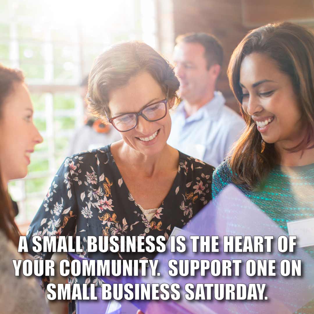 two women looking down with text "A small business is the heart of your community. Support one on small business saturday."