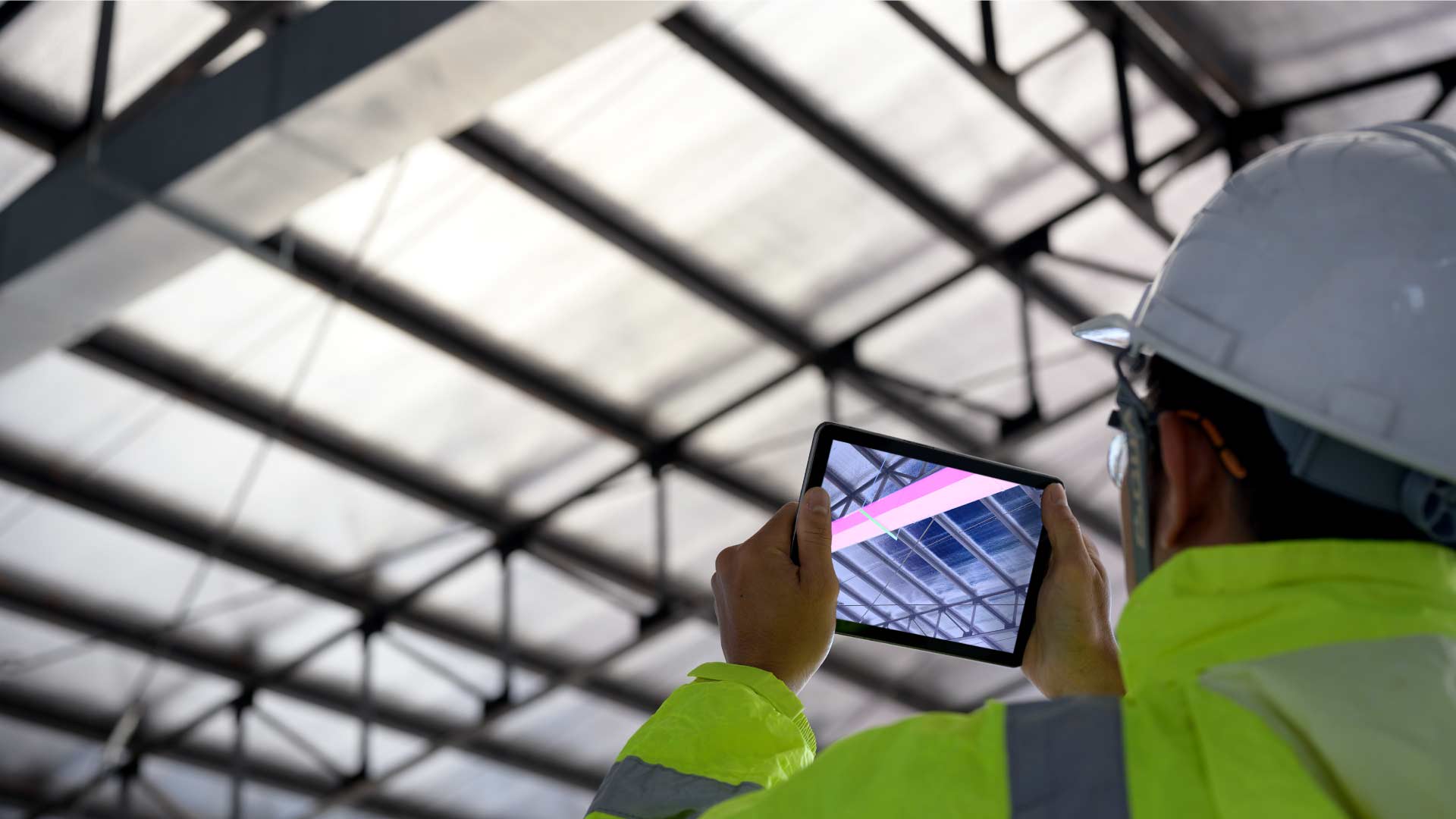 construction person taking a picture of a ceiling with their phone
