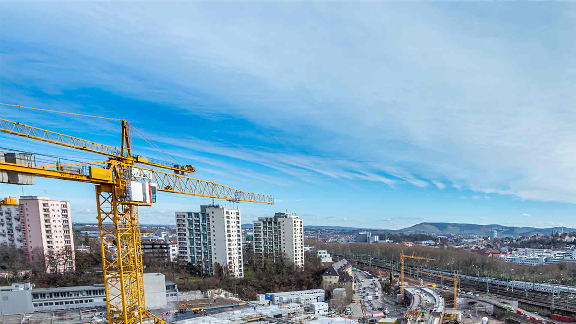 blue skies and skyscrapers and a crane