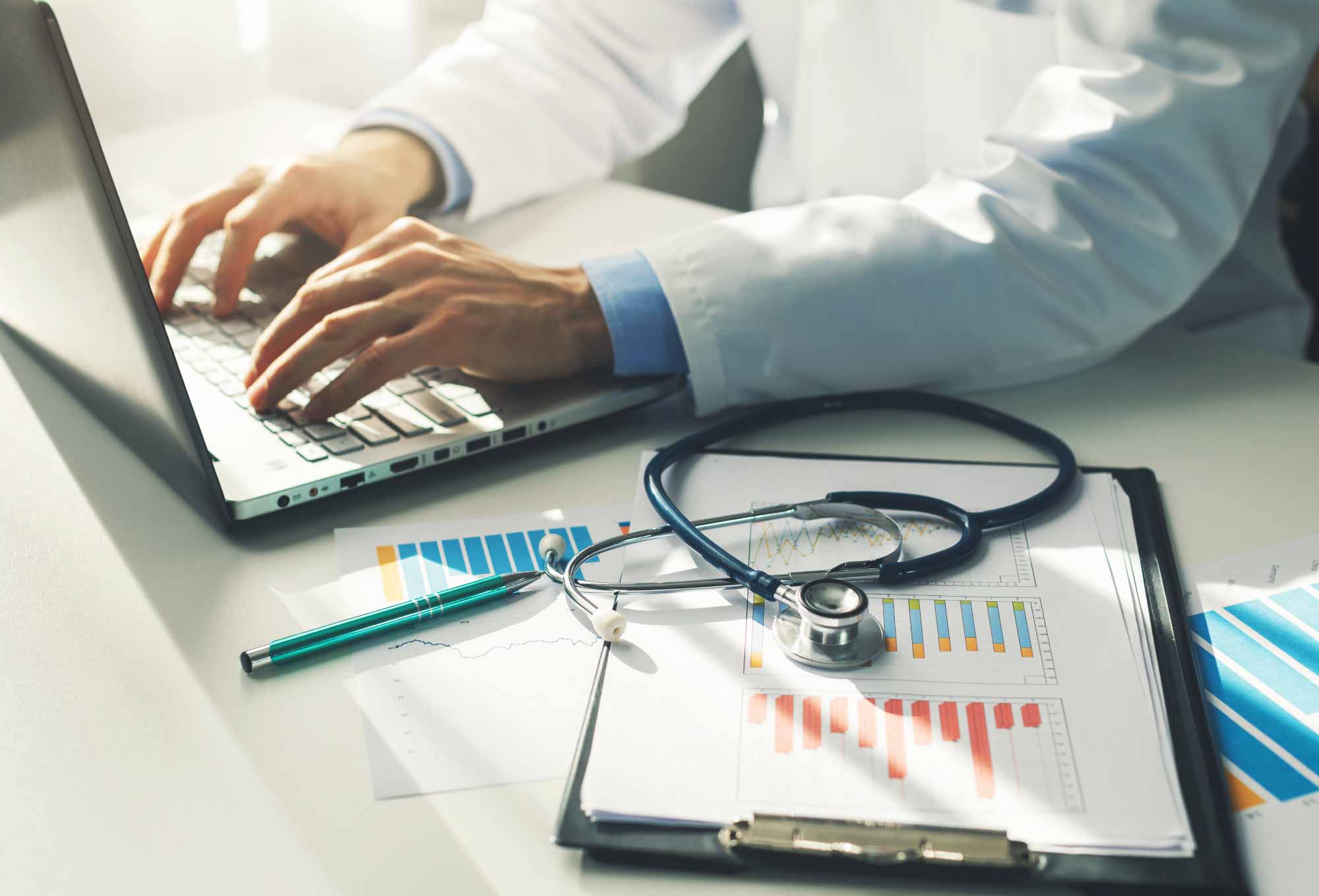 doctor typing in a laptop