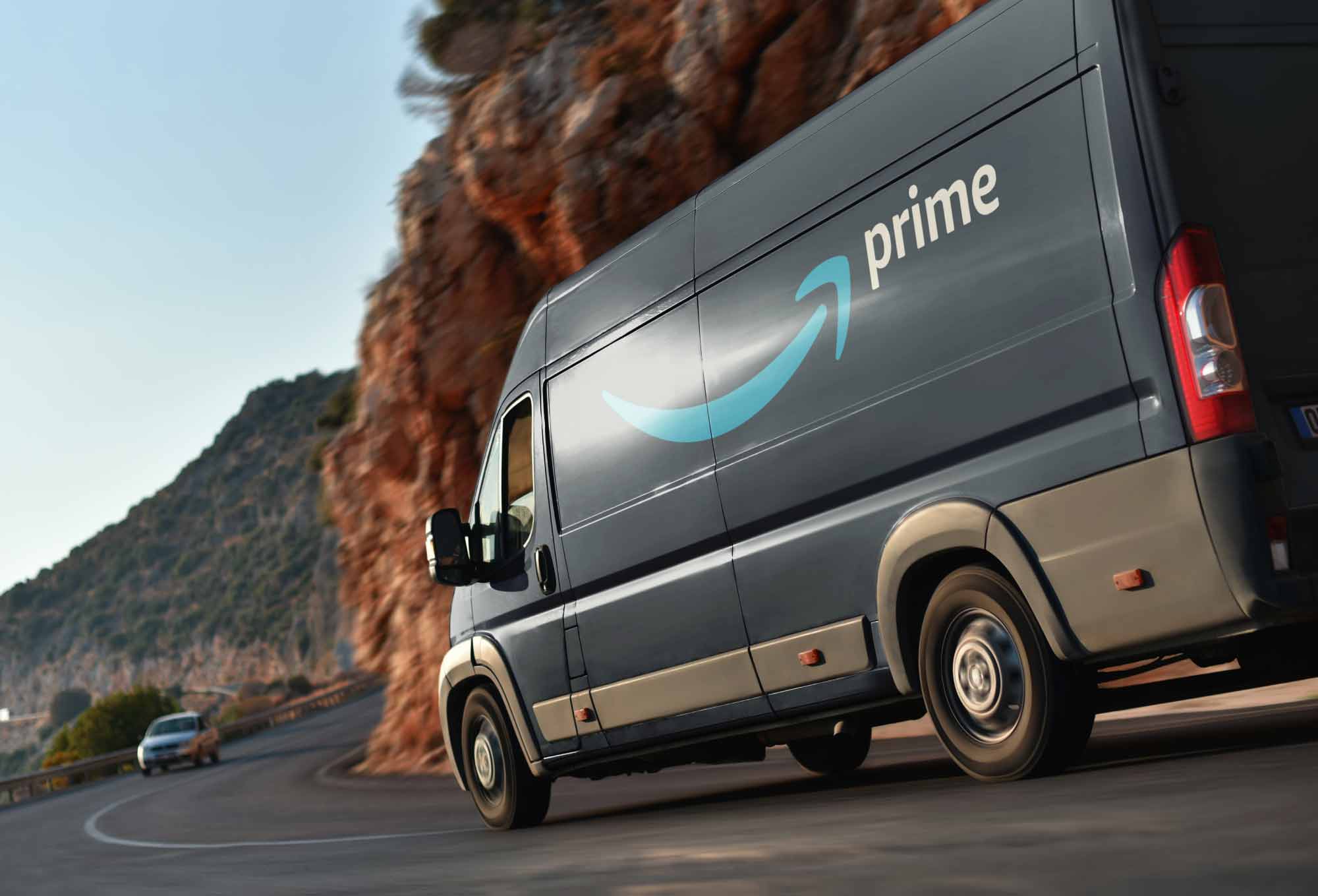 amazon truck in a highway with mountains