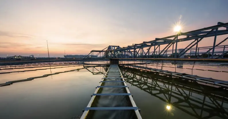 chemical plant over water and bridges, sunset