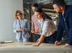 People Looking Over Table