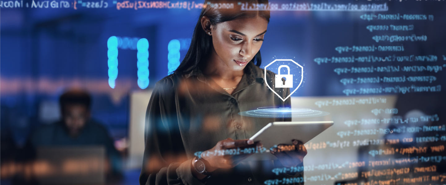Woman on a tablet through a translucent smartscreen with coding on it.