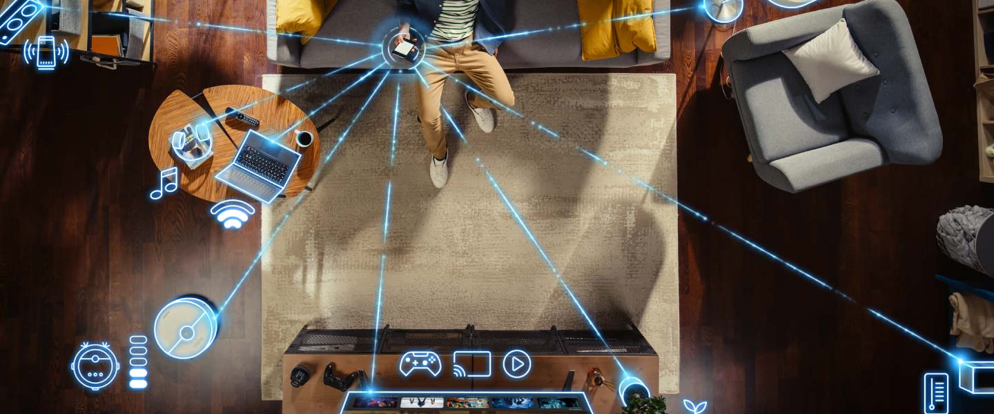 A person sitting on a couch with blue lines stemming out from a central device showing wireless connections. 