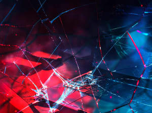 Shattered glass with red and blue light beneath it