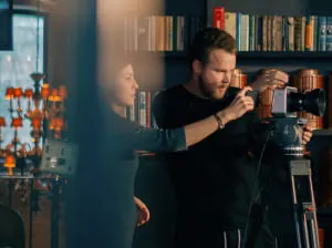 A pair of videographers working on perfecting a shot