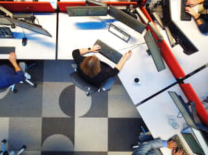 An overhead shot of two professionals sitting at their work stations.